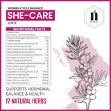 Bottle of Nature's Hive She Care Herbal Juice, 1 liter, with fresh herbs visible in the natural herbal blend on the label.