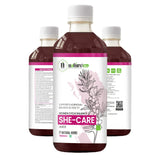 Bottle of Nature's Hive She Care Herbal Juice, 1 liter, with fresh herbs and ingredients visible in the clear container.